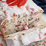slices of strawberry bread being cut off a loaf.