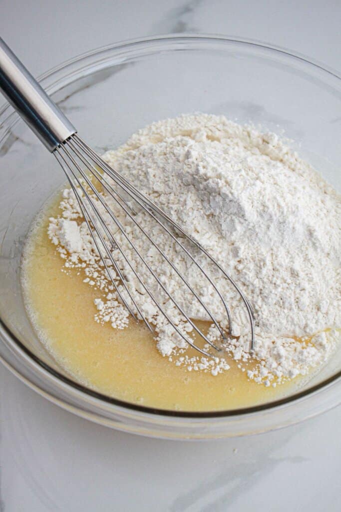 strawberry bread batter being mixed in a large glass bowl.