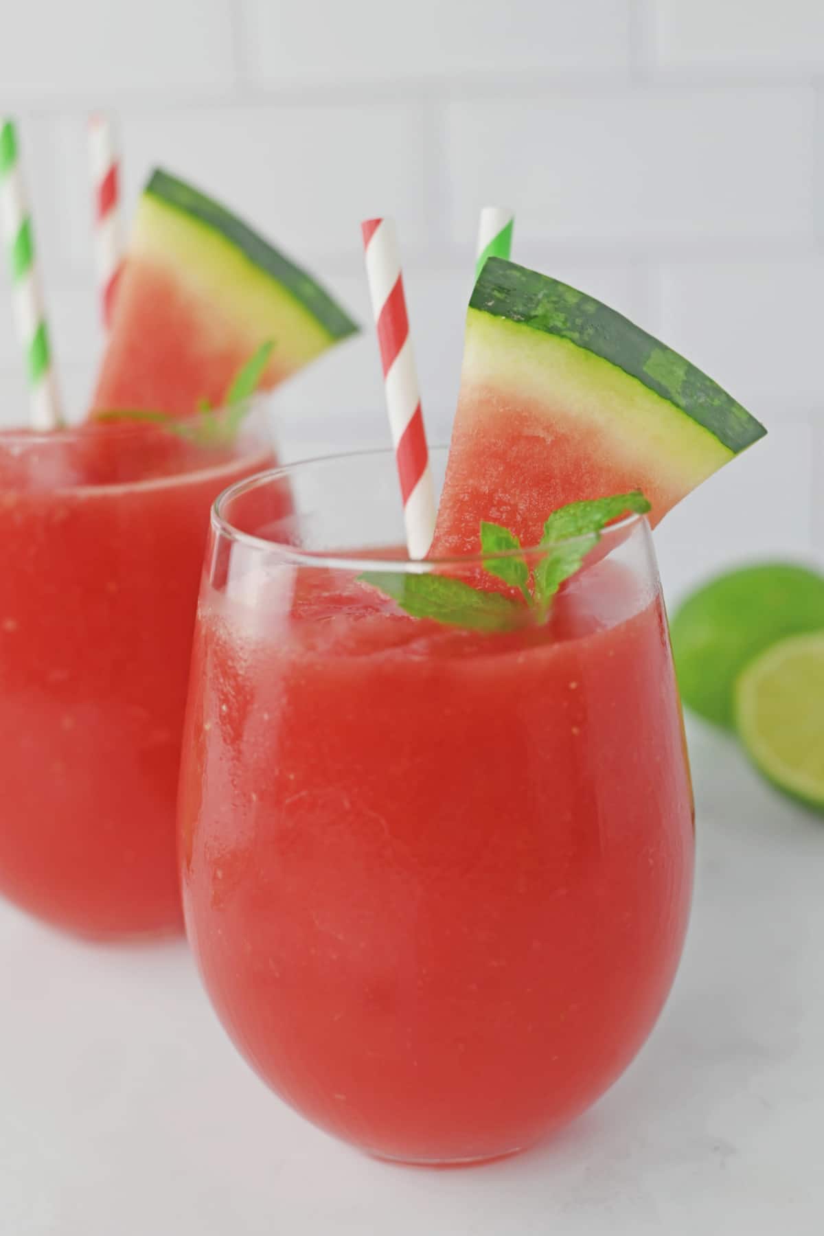 two watermelon slushes on a counter.