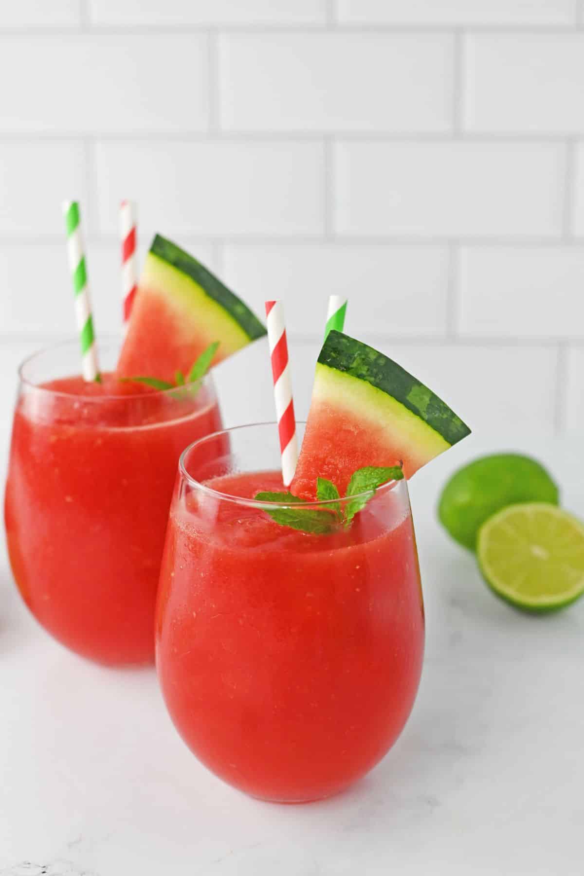two watermelon slushes on a counter.