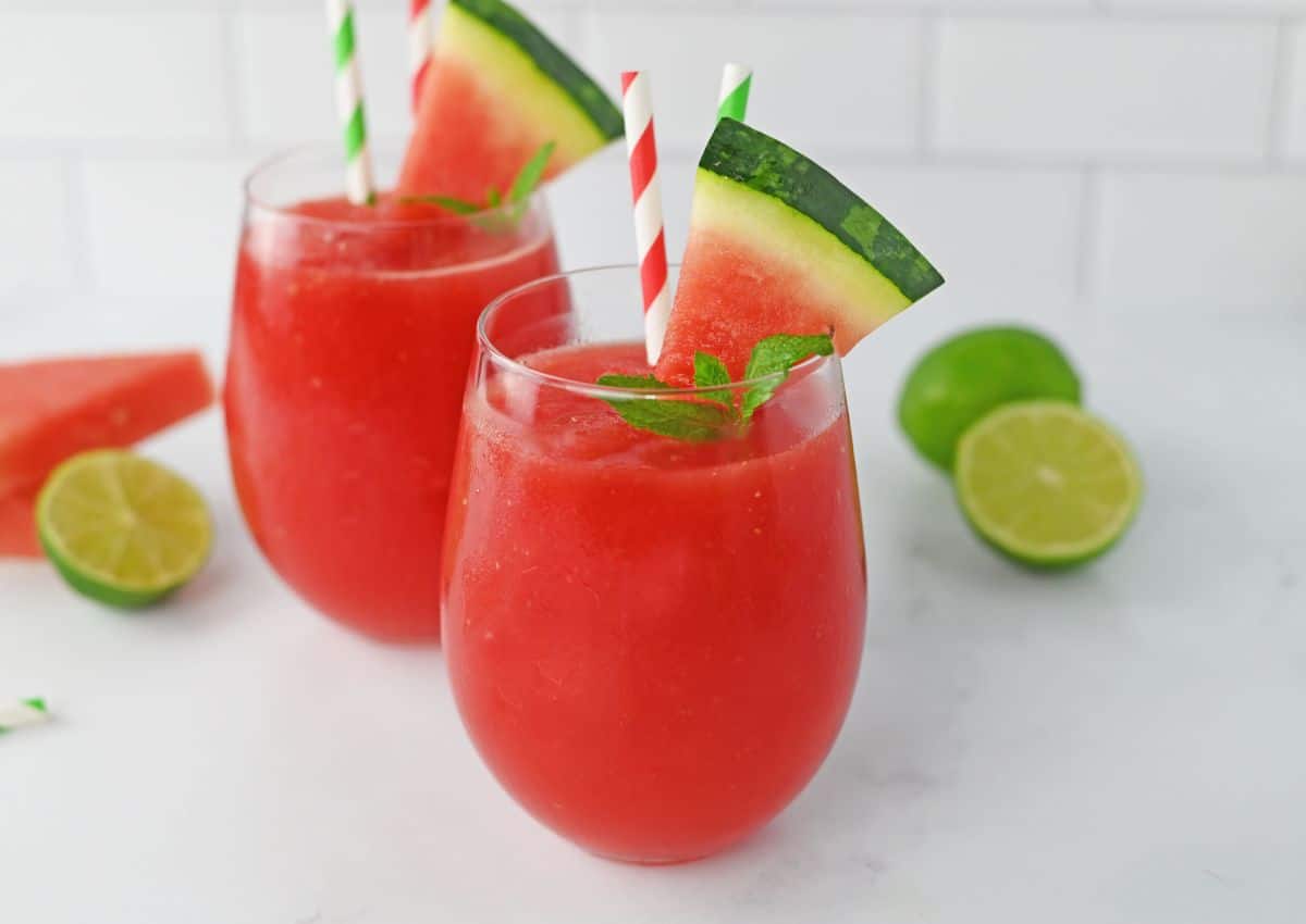 two watermelon slushes on a counter.