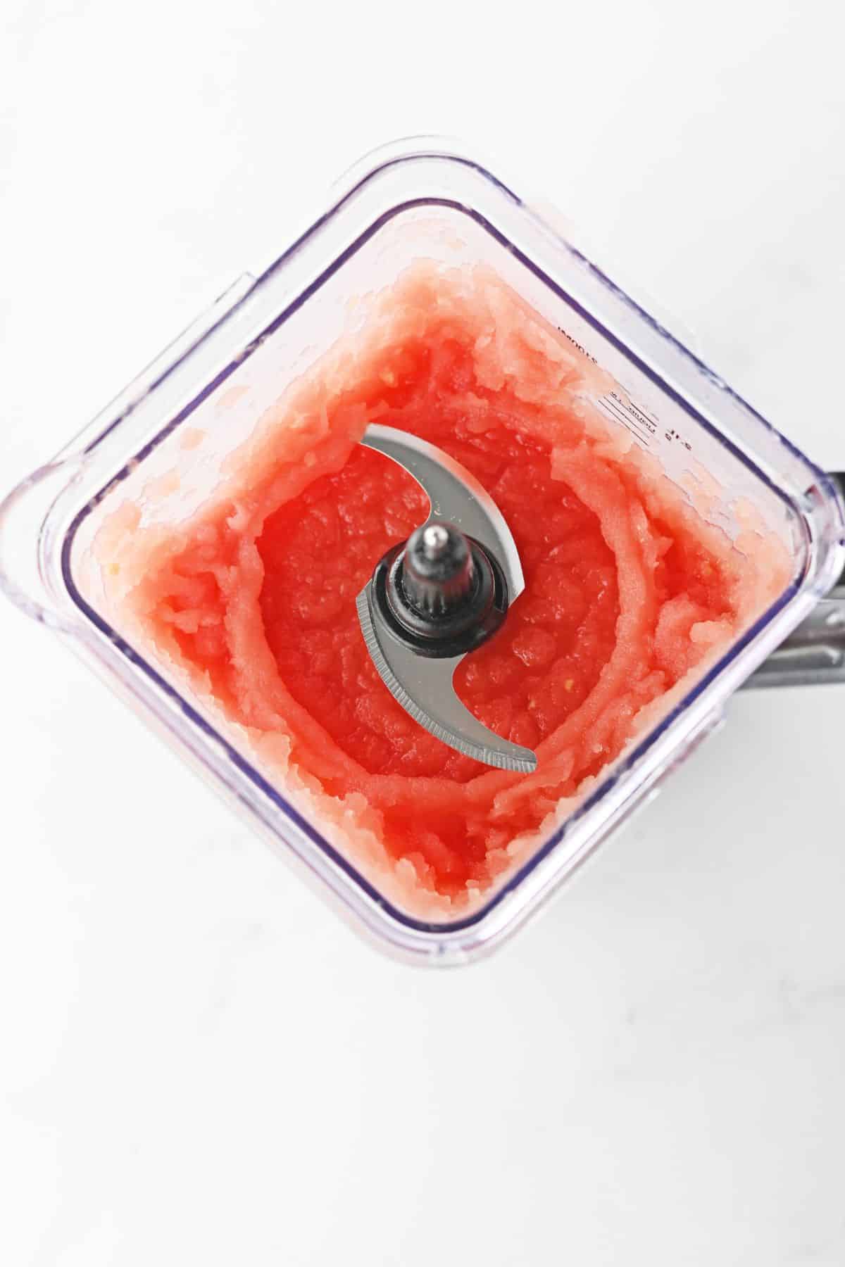ingredients being pulsed in a blender to a icy consistency.