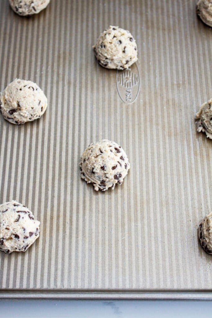 cookie dough scoops on a baking sheet ready for the oven.