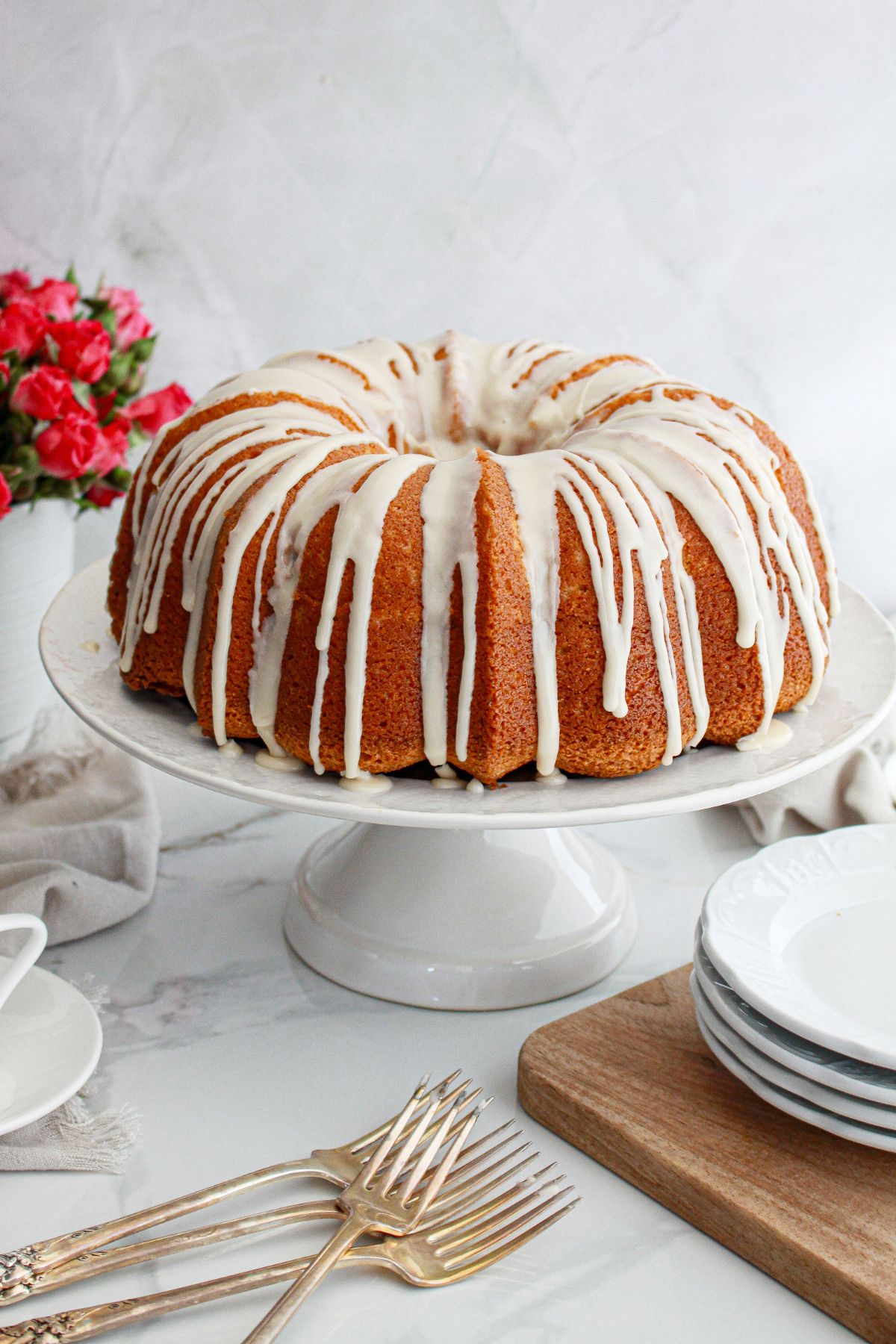 uncut coffee cake pound cake on a cake stand.