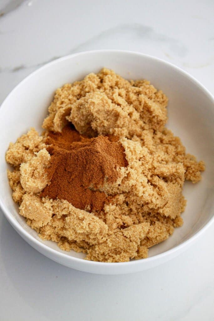 brown sugar and cinnamon being mixed together in a small bowl.
