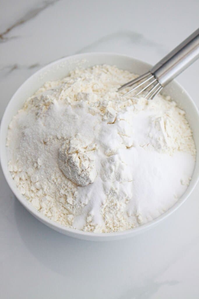 dry ingredients being mixed in a small bowl with a whisk.