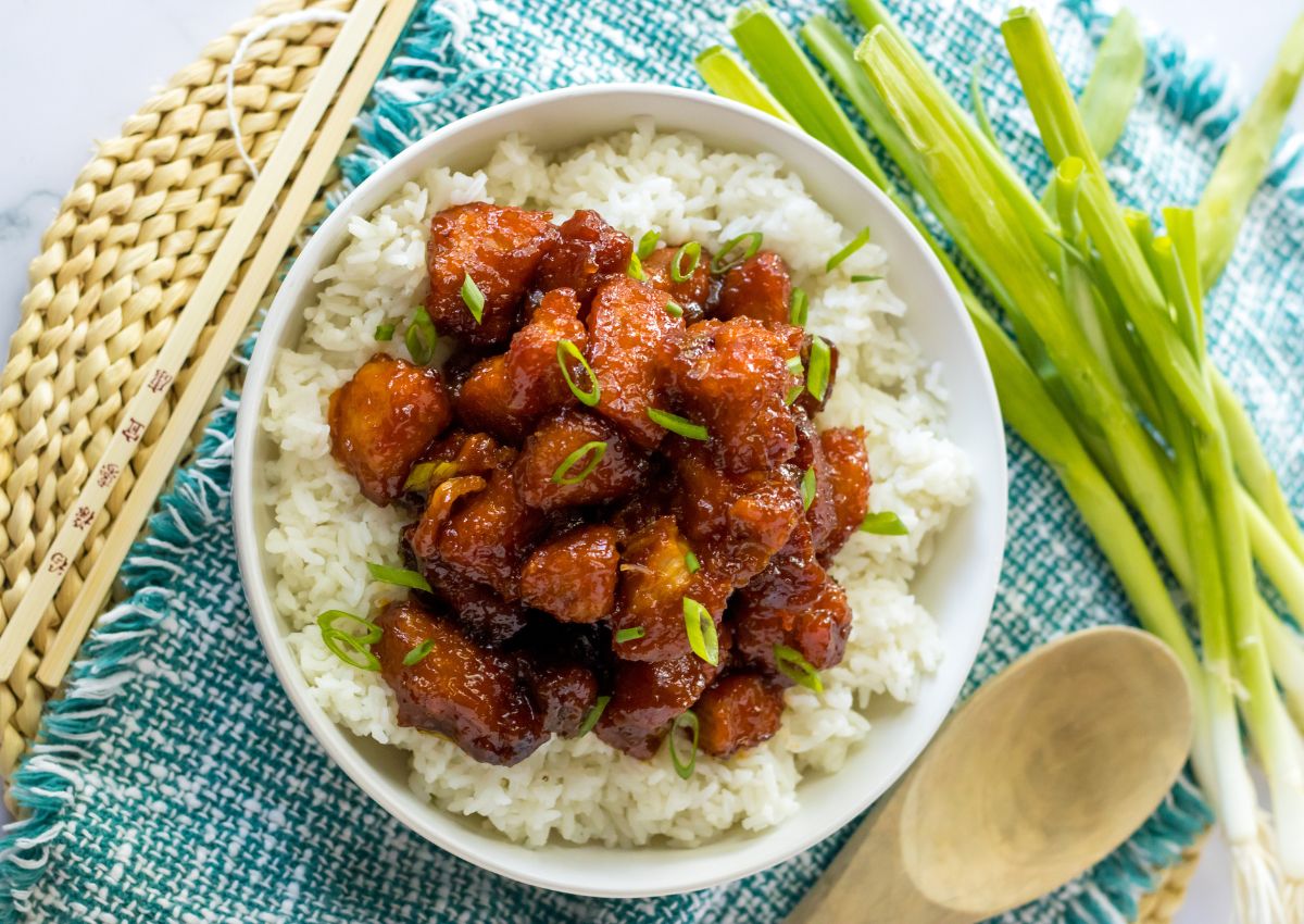 bowl of rice and topped with firecracker chicken.