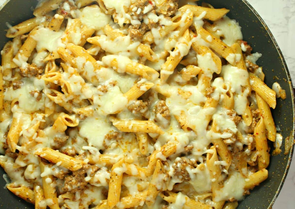 skillet full of ground beef pasta.