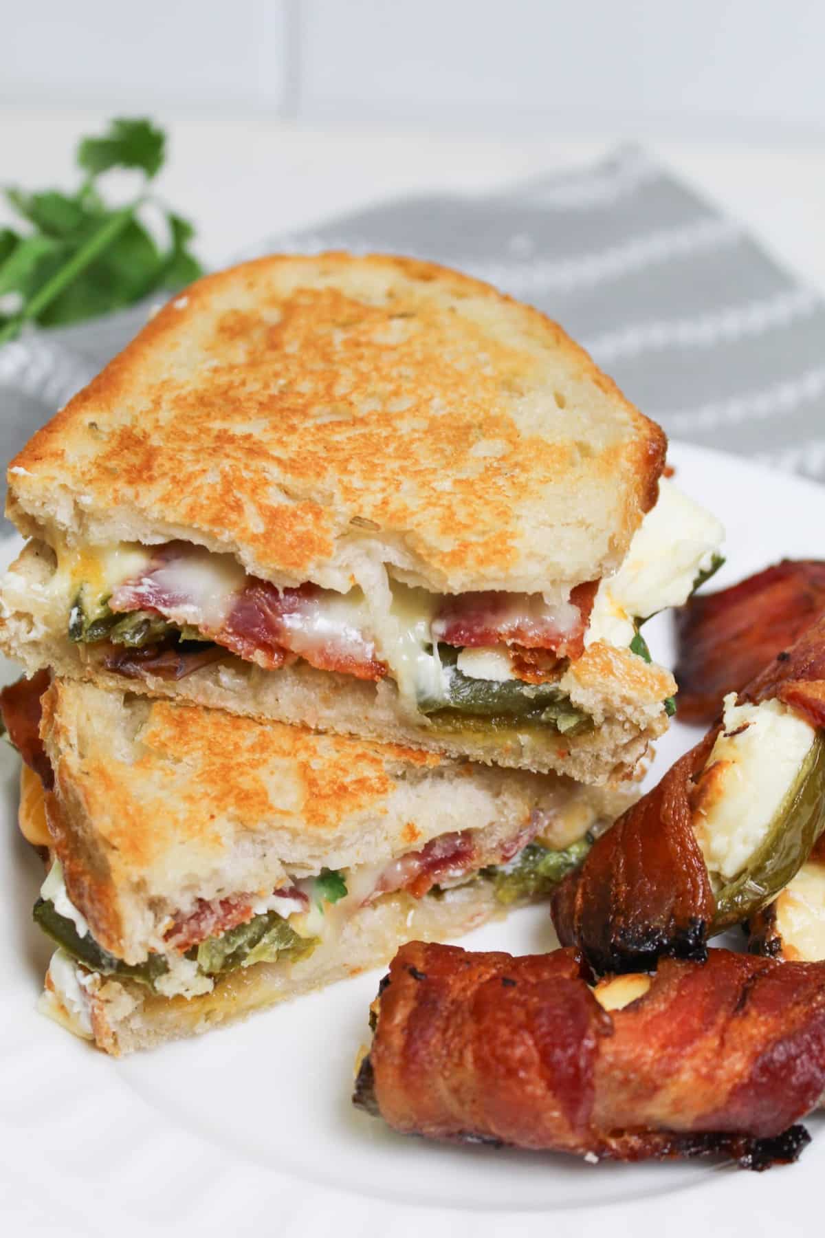 two halves of jalapeno popper grilled cheese sandwiches on a plate.