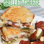 two halves of jalapeno popper grilled cheese sandwiches on a plate.