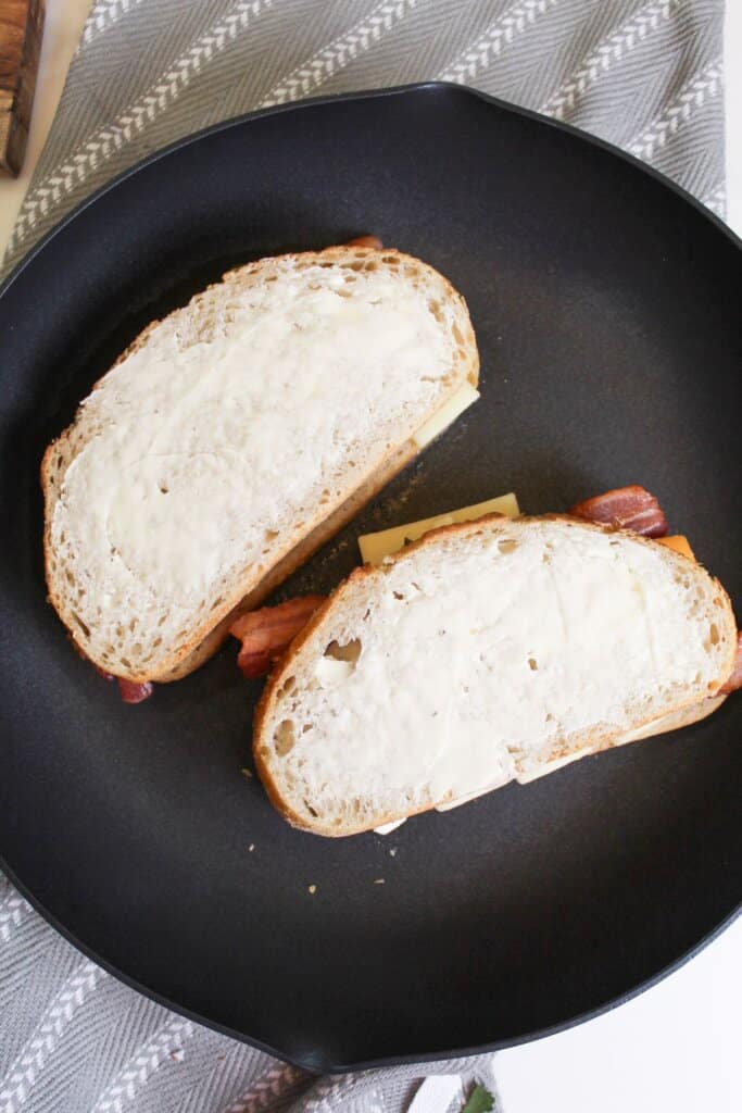 grilled cheese being toasted in a skillet.