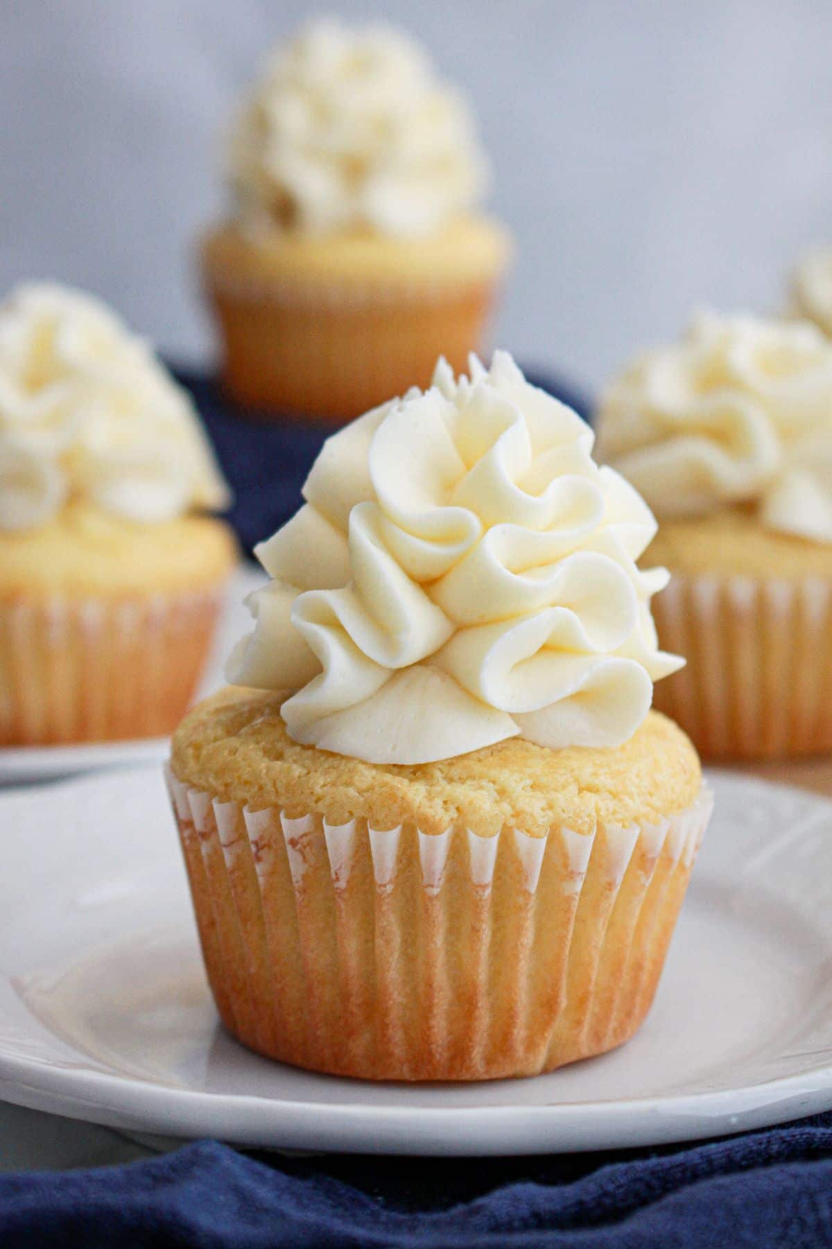lemon cream cheese cupcakes on a small plate. 