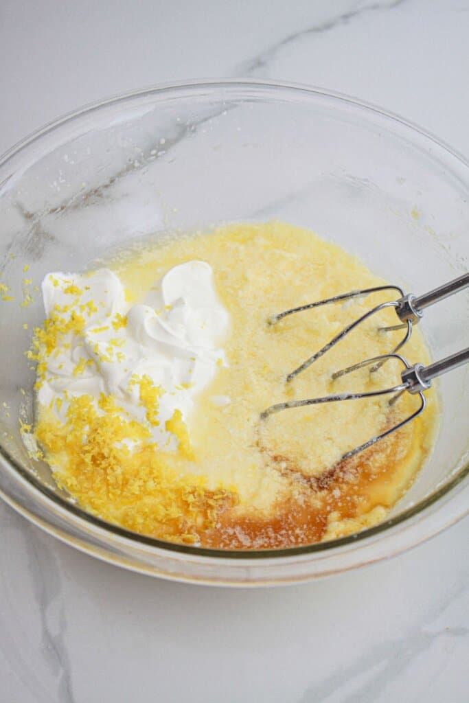wet ingredients for batter being mixed in a large mixing bowl.
