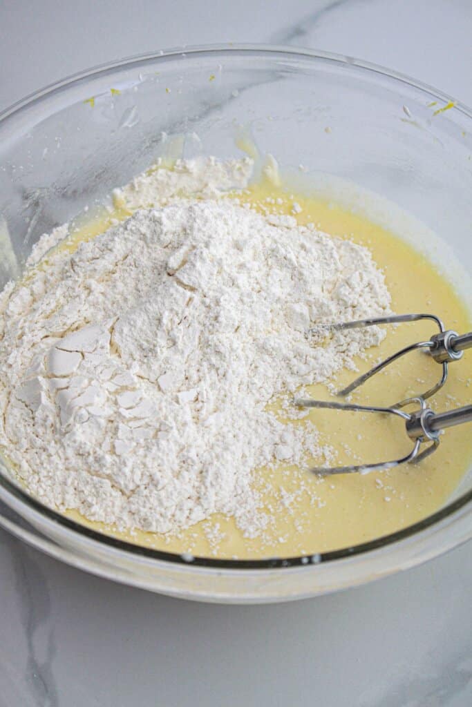 cupcake batter being mixed in a large bowl.