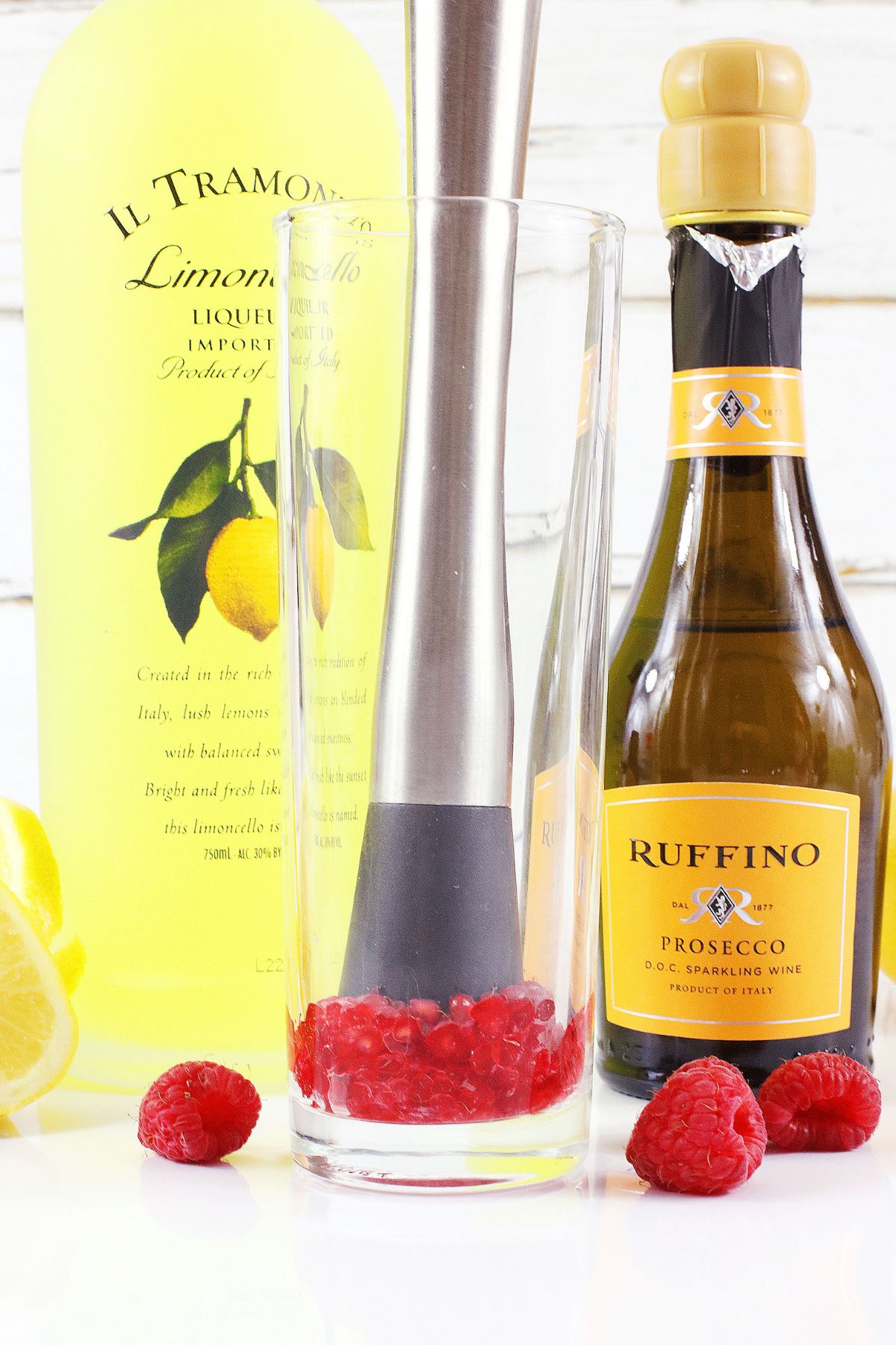 berries being muddle in a champagne glass.