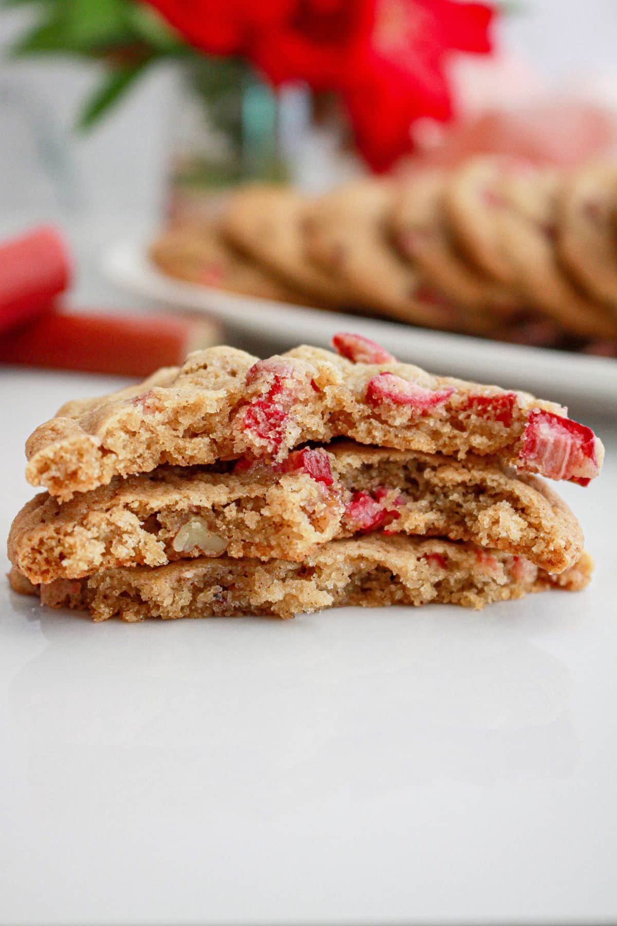 three halves of pecan rhubarb cookies on a counter.