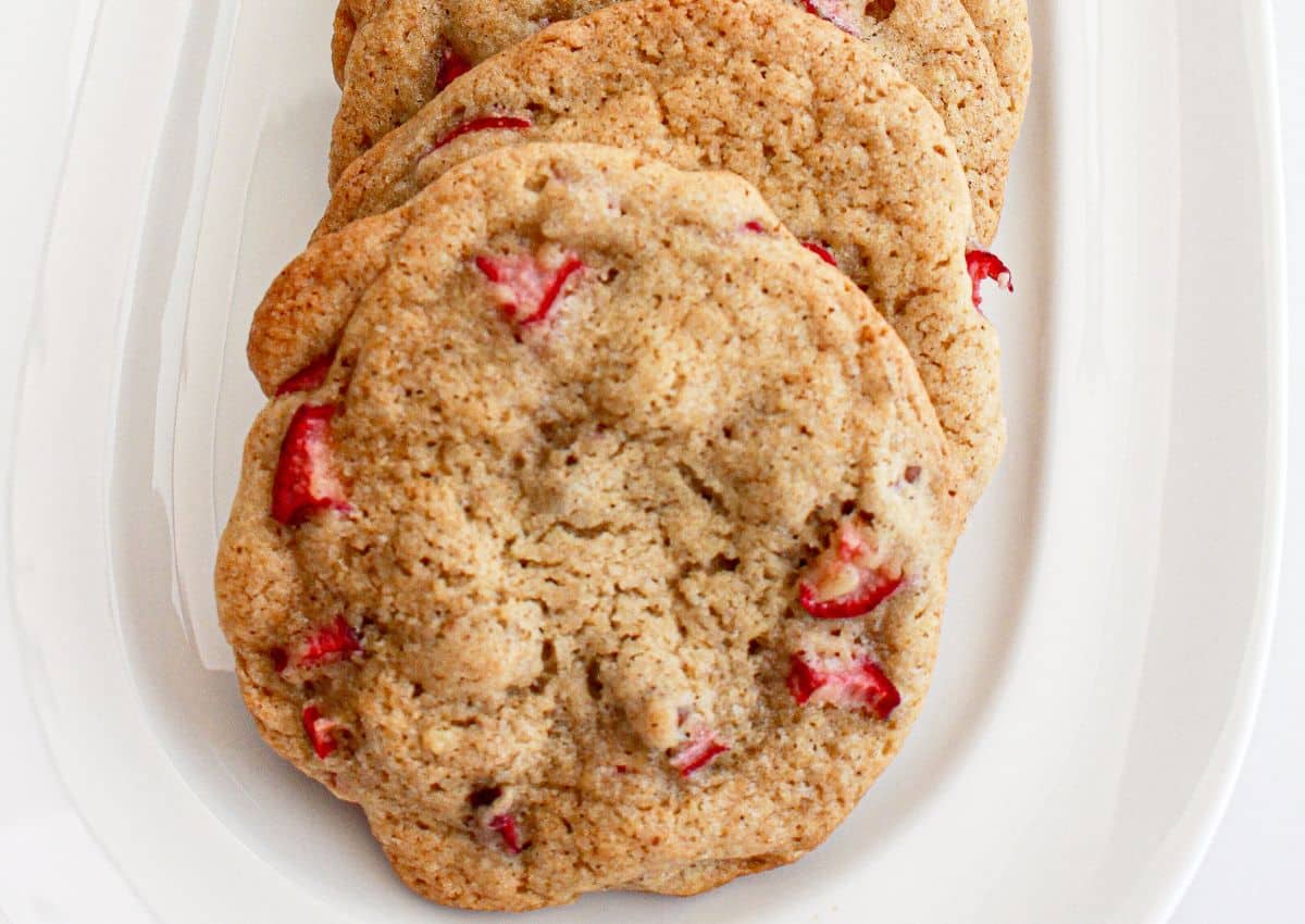 three pecan rhubarb cookies on a serving plate.