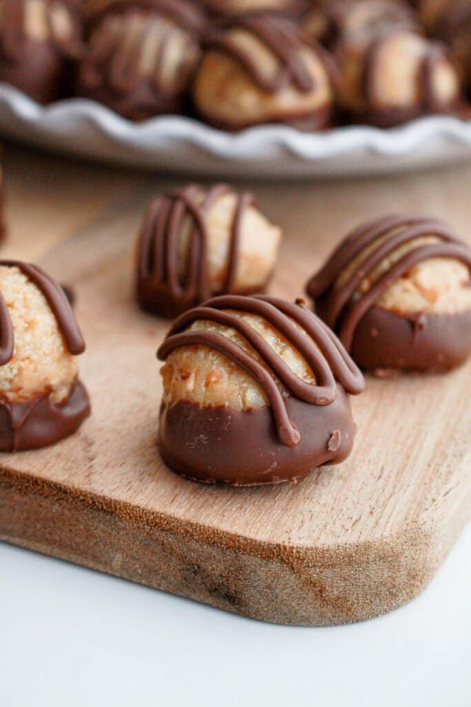 samoa truffles on a wooden cutting board.