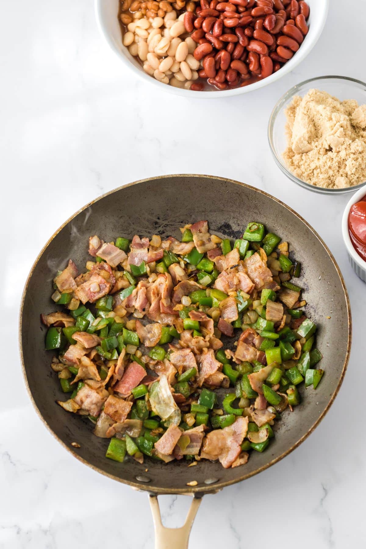 bacon and bell peppers in a large skillet.