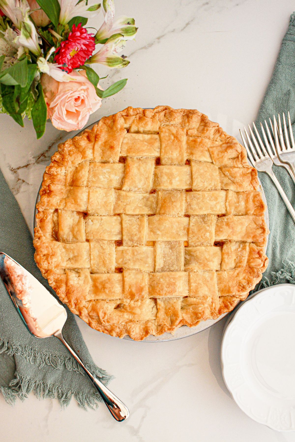 uncut peach pie on a table.