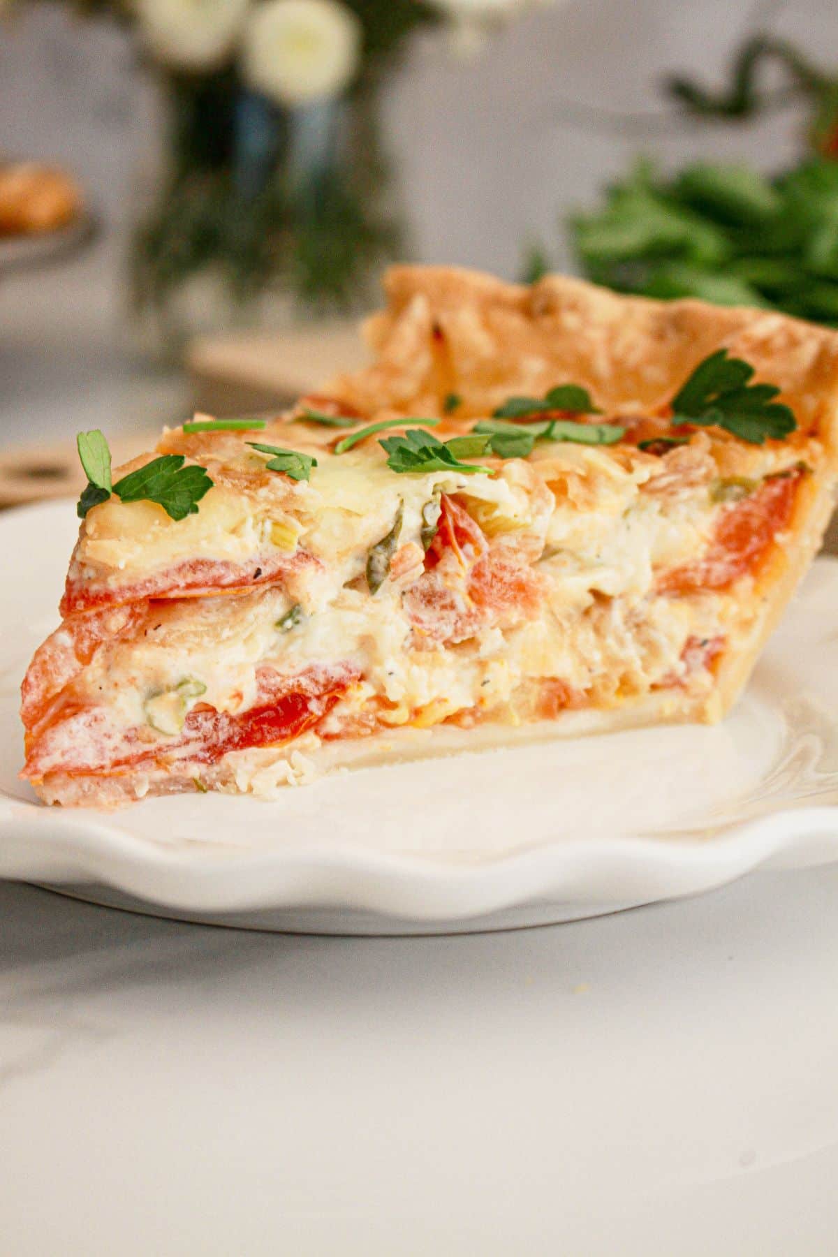slice of southern tomato pie on a small plate.