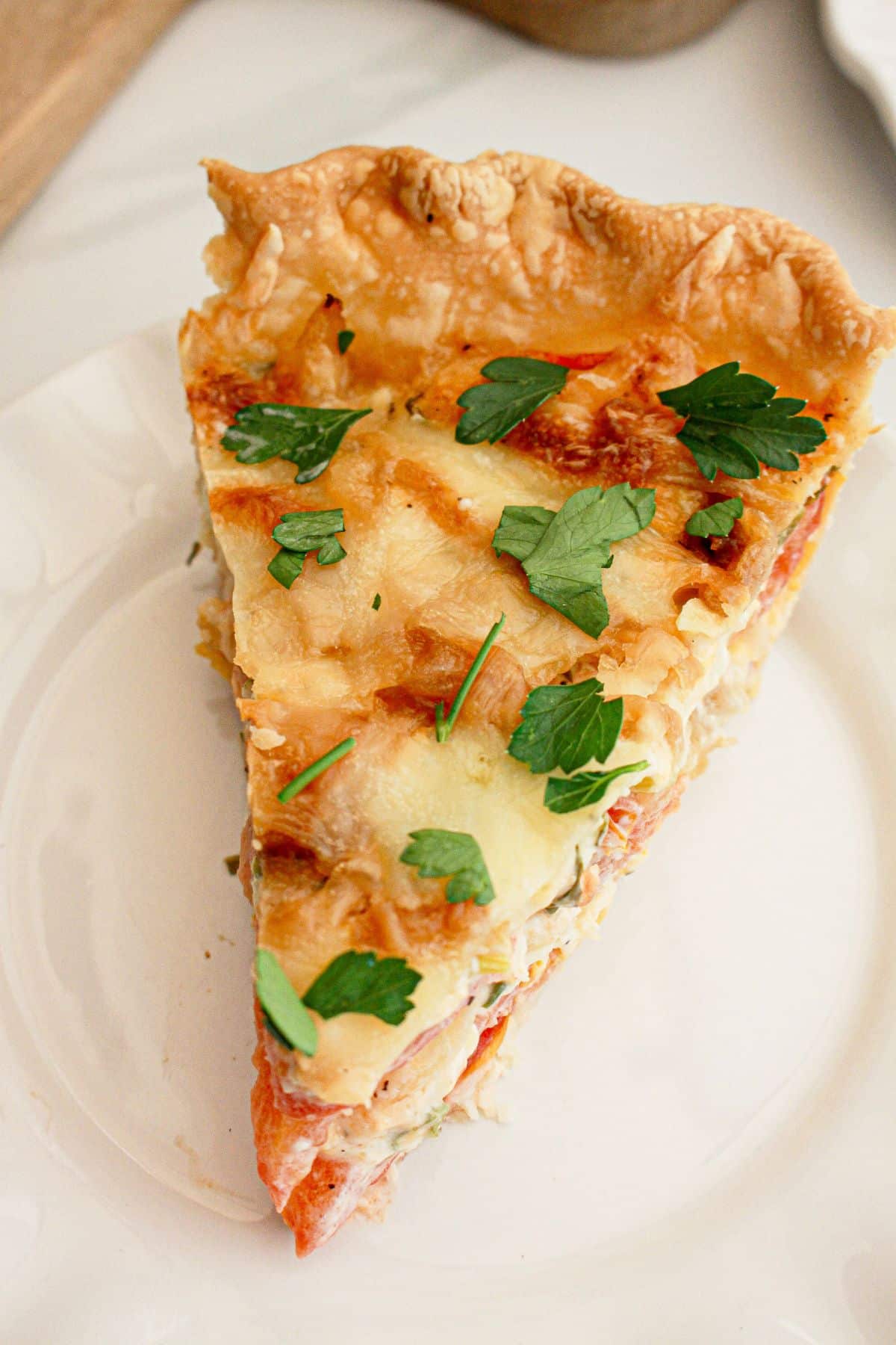 slice of southern tomato pie on a small plate.