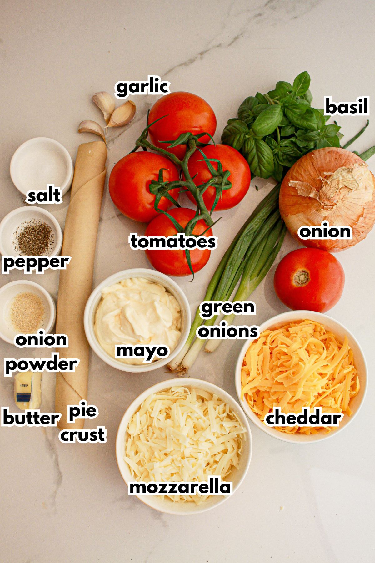bowls of ingredients needed to make southern tomato pie on a counter.