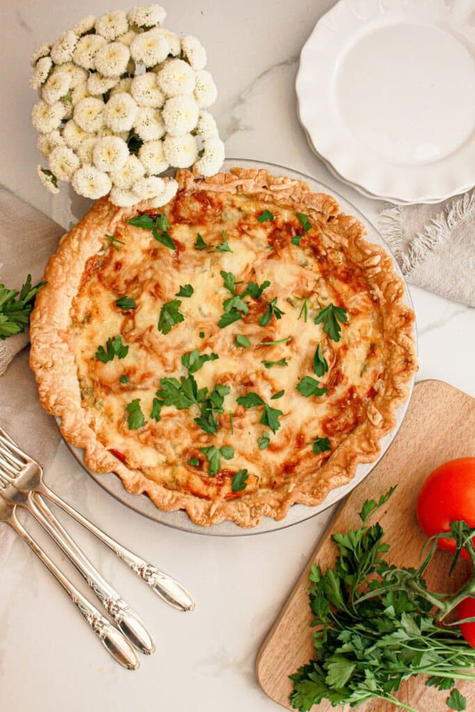 uncut baked southern tomato pie on a table.