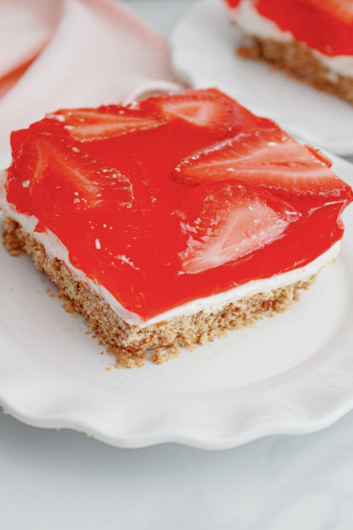 slice of strawberry pretzel salad on a plate.
