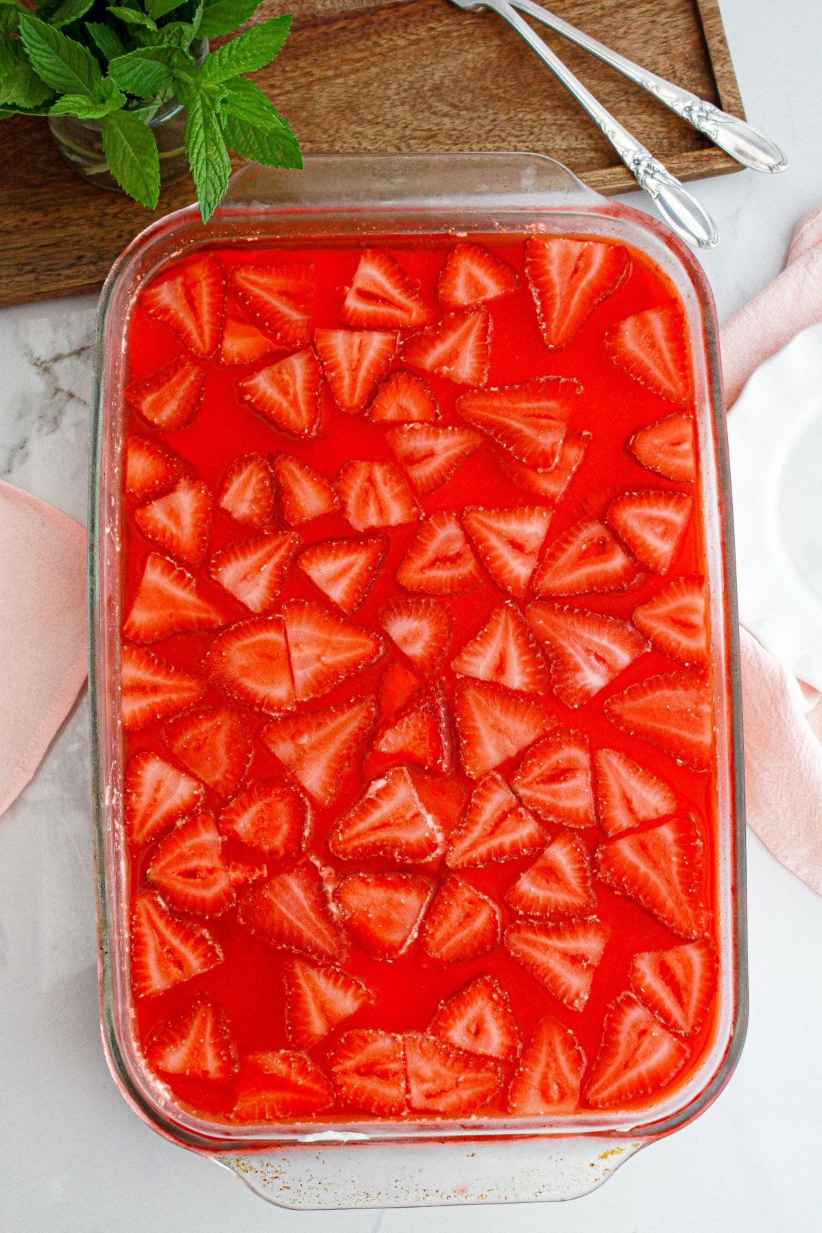 uncut strawberry pretzel salad in a glass baking dish.