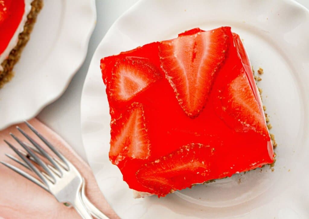 slice of strawberry pretzel salad on a plate.