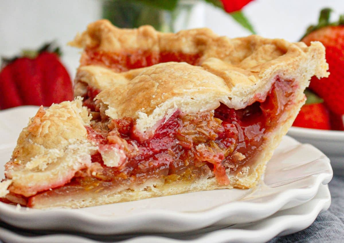 slice of strawberry rhubarb pie on a small plate.