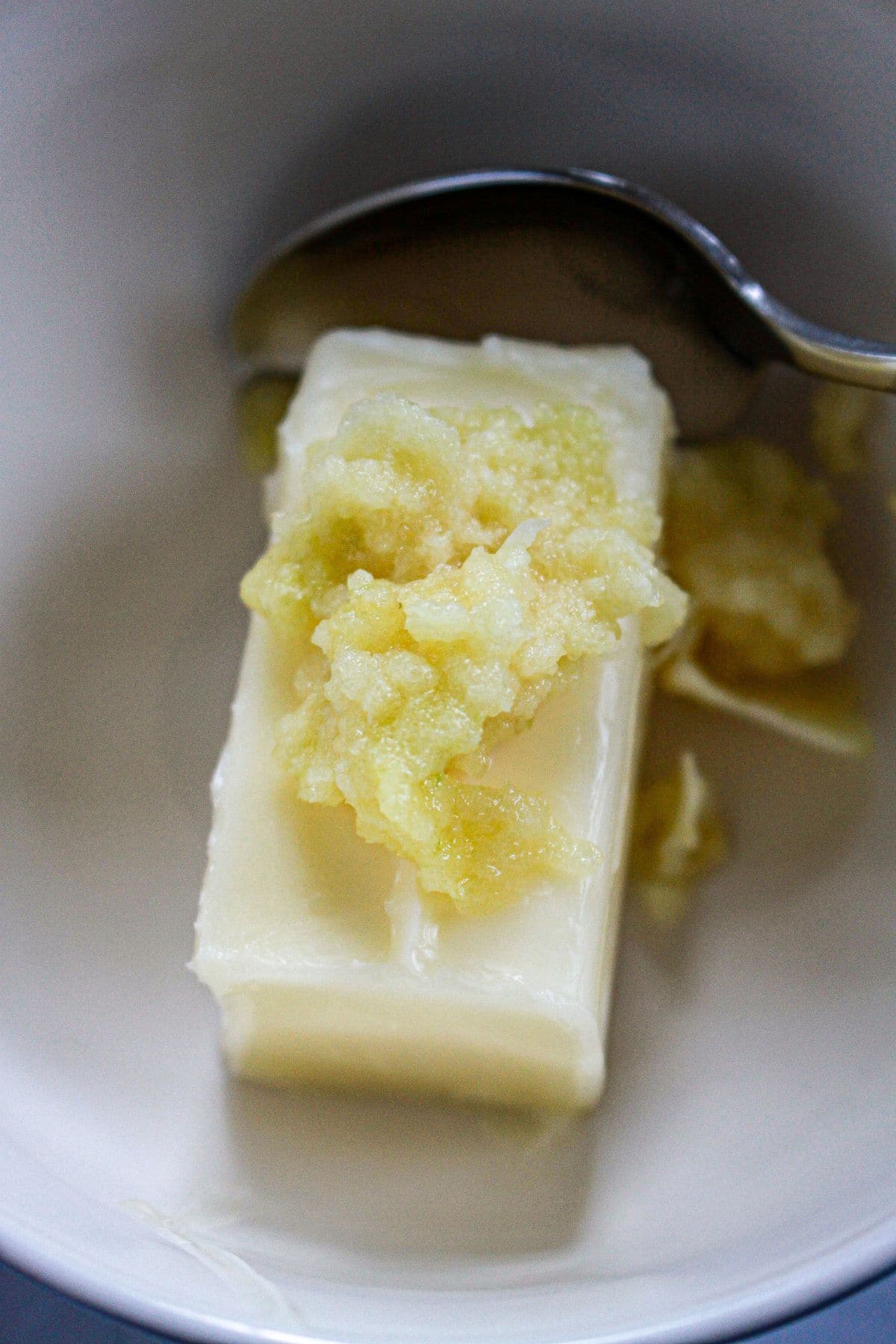 butter and seasonings being mixed in a bowl.