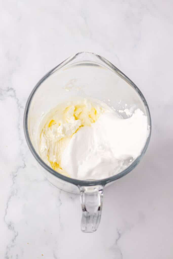 whipped cream and marshmallow cream being mixed together.