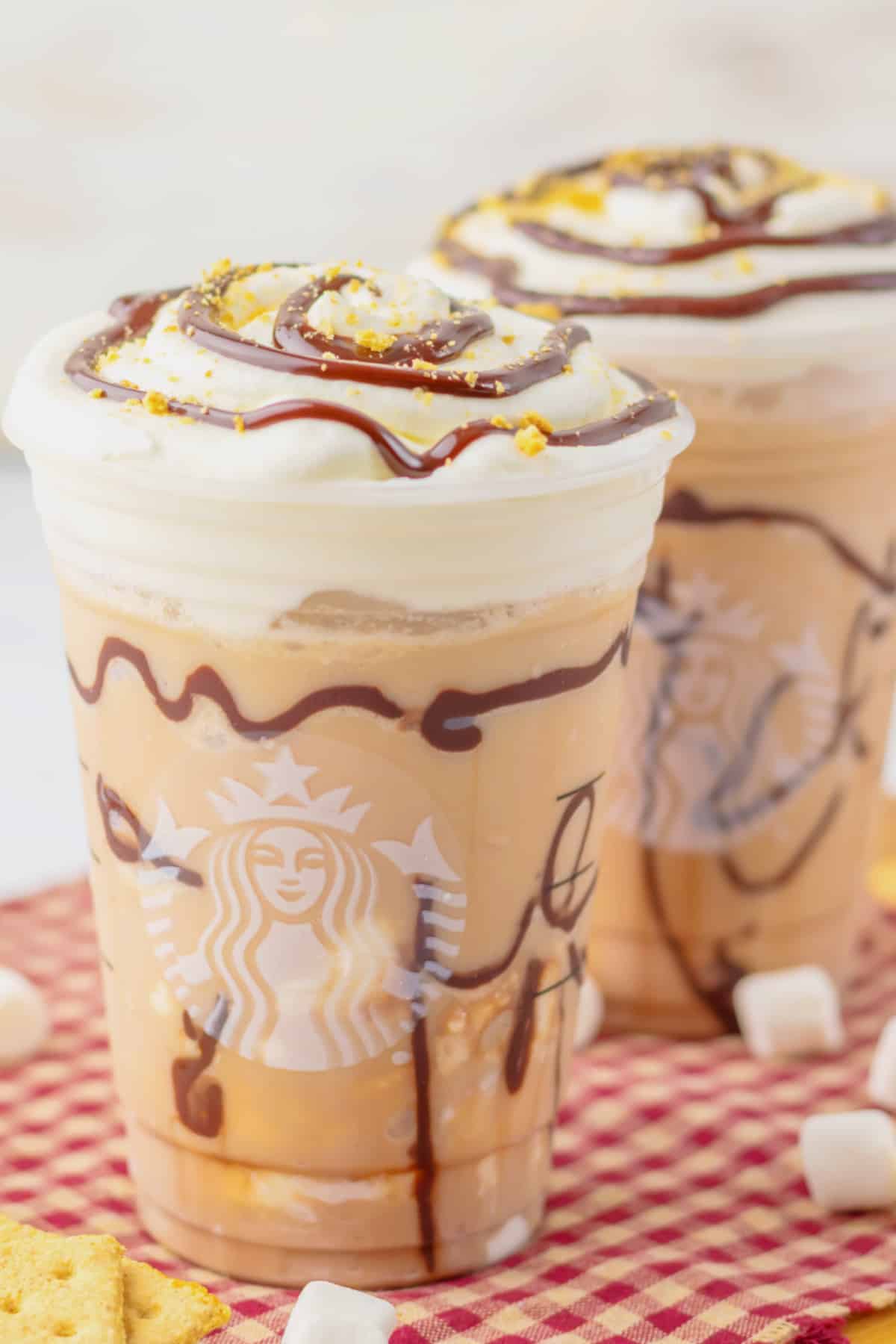 Two smores frappuccinos on a counter.