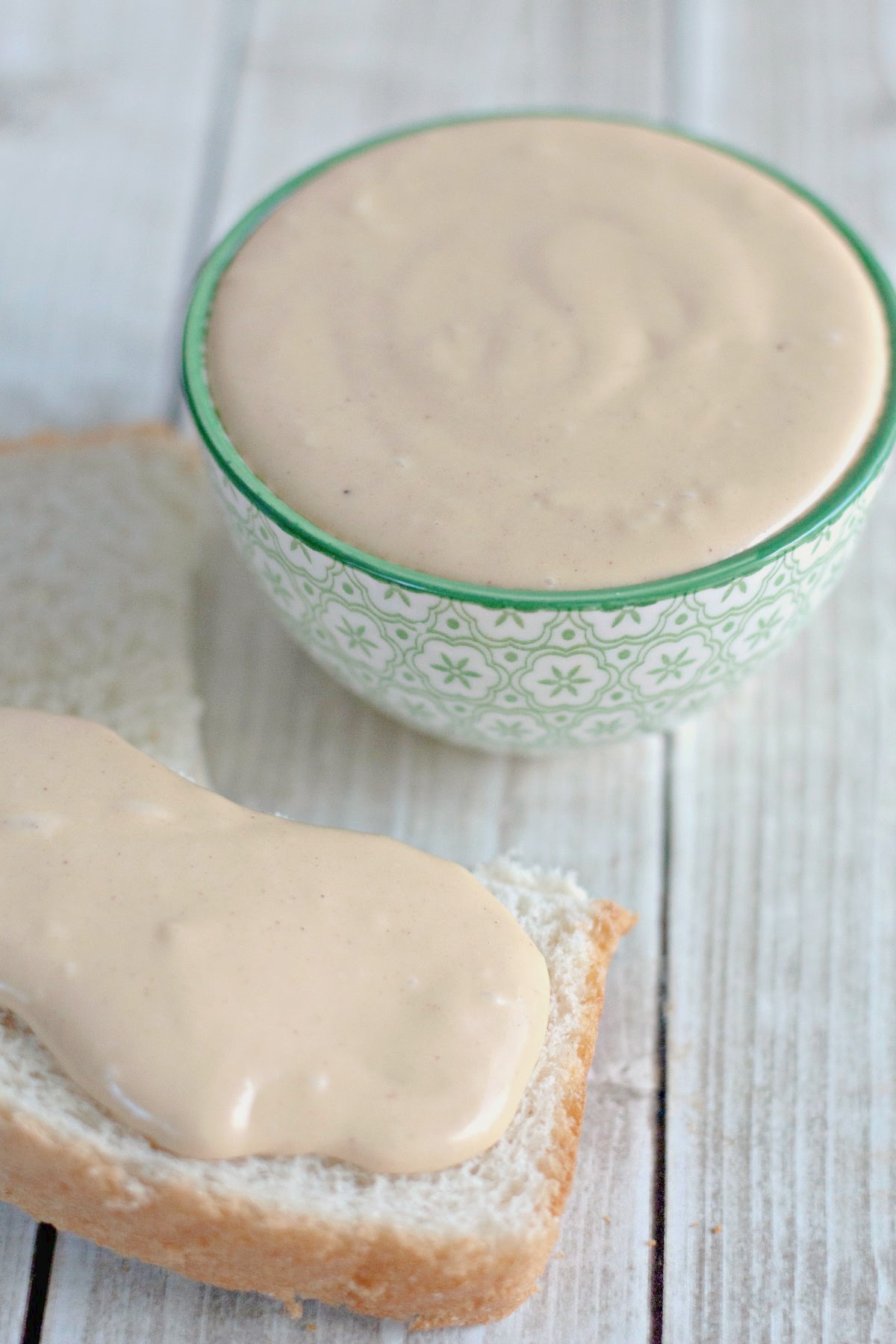 Half slice of bread topped with amish peanut butter spread on the counter.