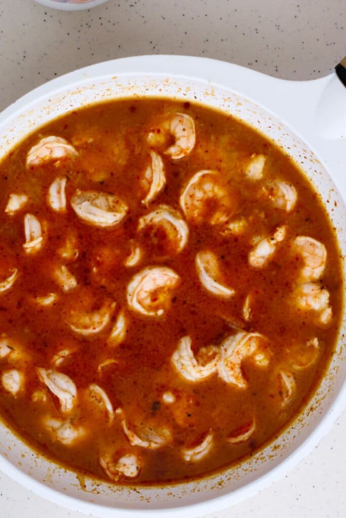 Shrimp cooking in a skillet.