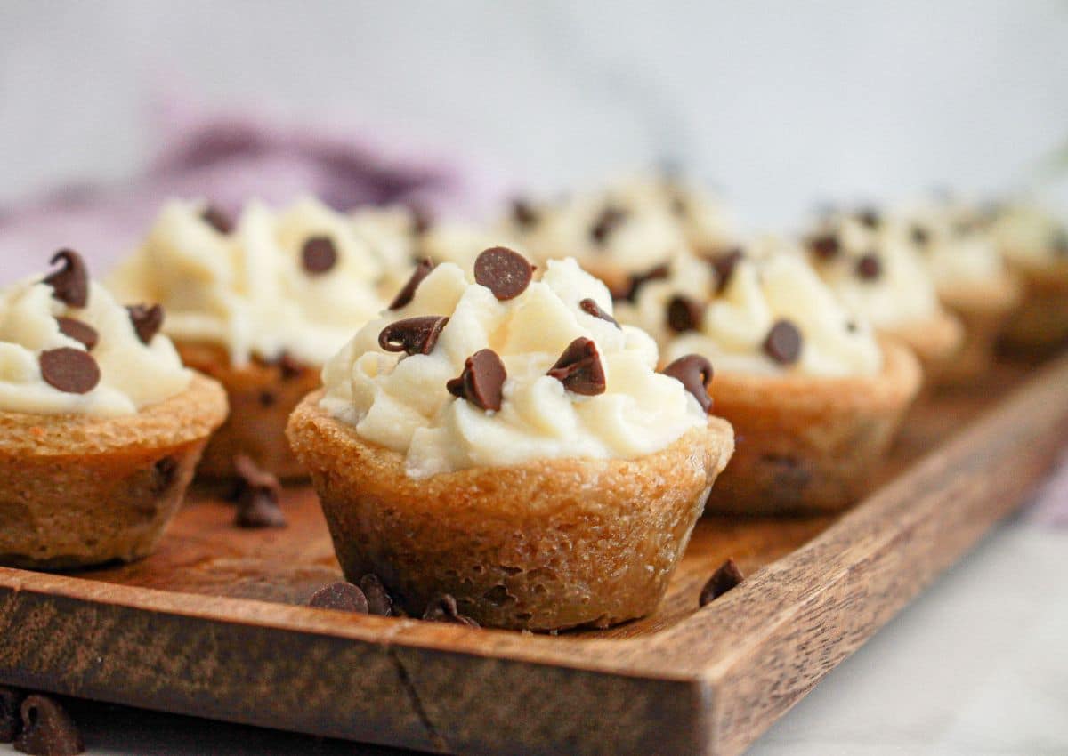 mini cannoli cookie cups on a wooden serving tray.