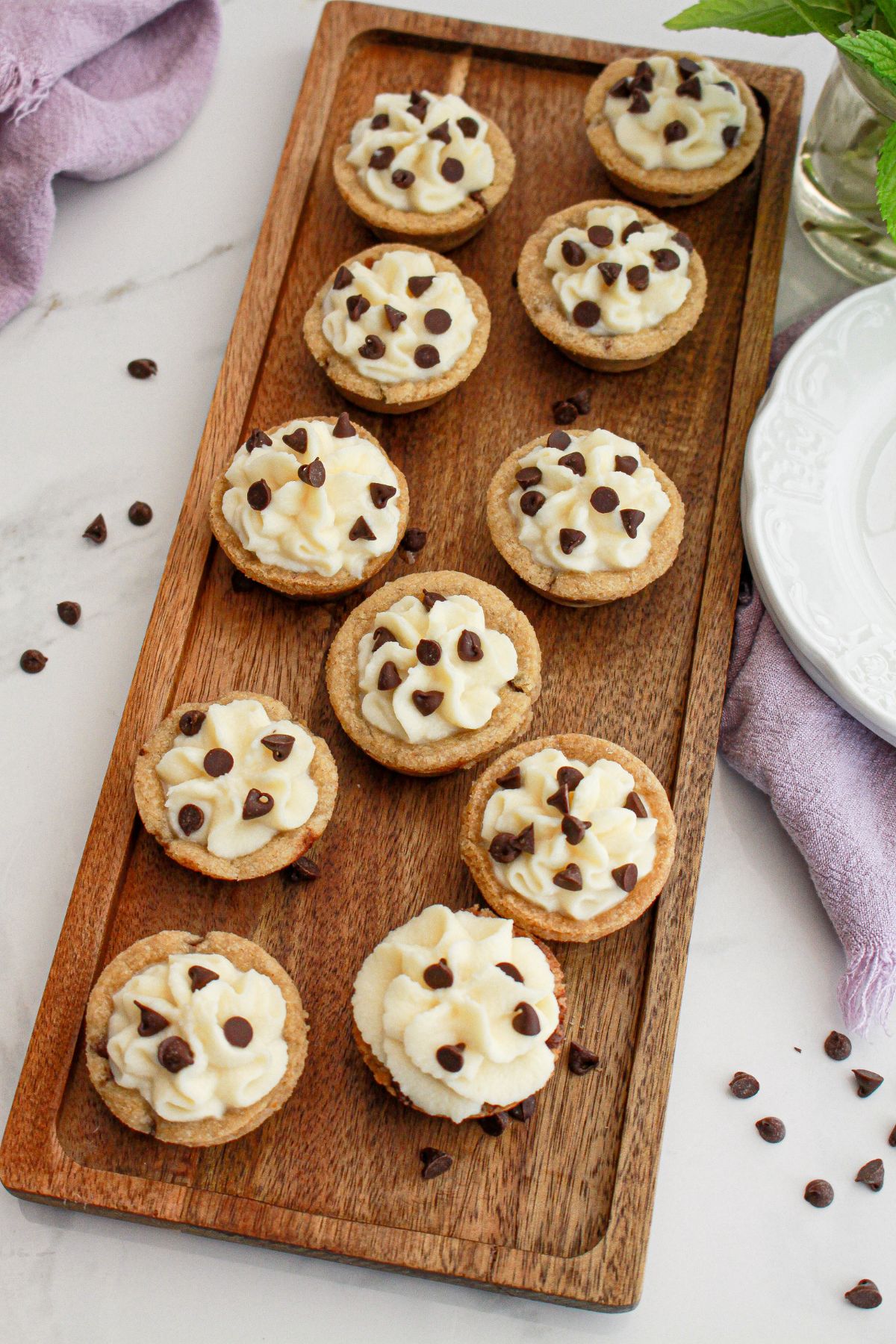 mini cannoli cookie cups on a wooden serving tray.