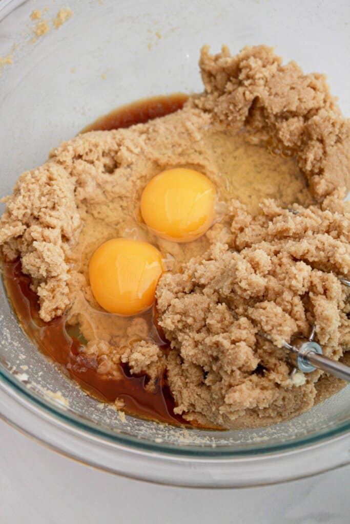 eggs being added to sugar and in a large bowl.