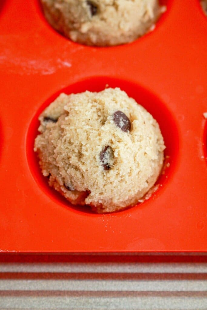 cookie dough in a mini muffin pan.