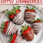 Six chocolate dipped strawberries on a plate.
