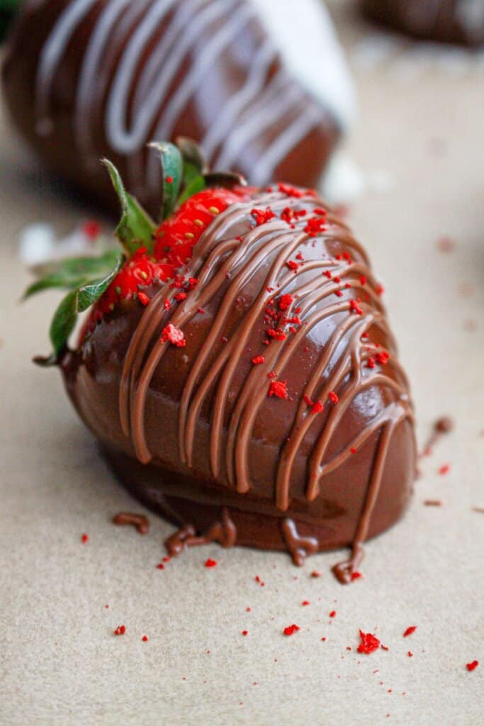 Delicious chocolate dipped strawberry on a parchment lined baking sheet.