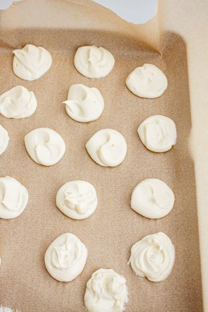 Cheesecake filling being frozen on a parchment lined baking sheet.