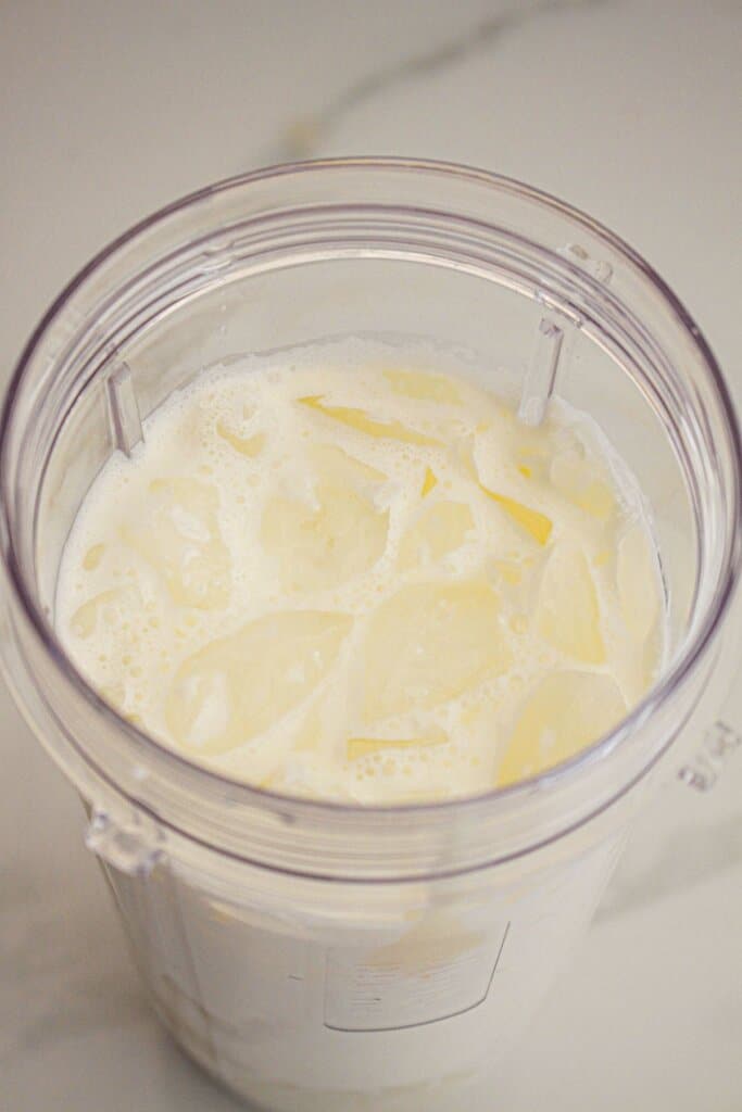 ingredients being mixed in a personal sized blender.