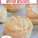 honey butter biscuits on a parchment lined baking sheet.