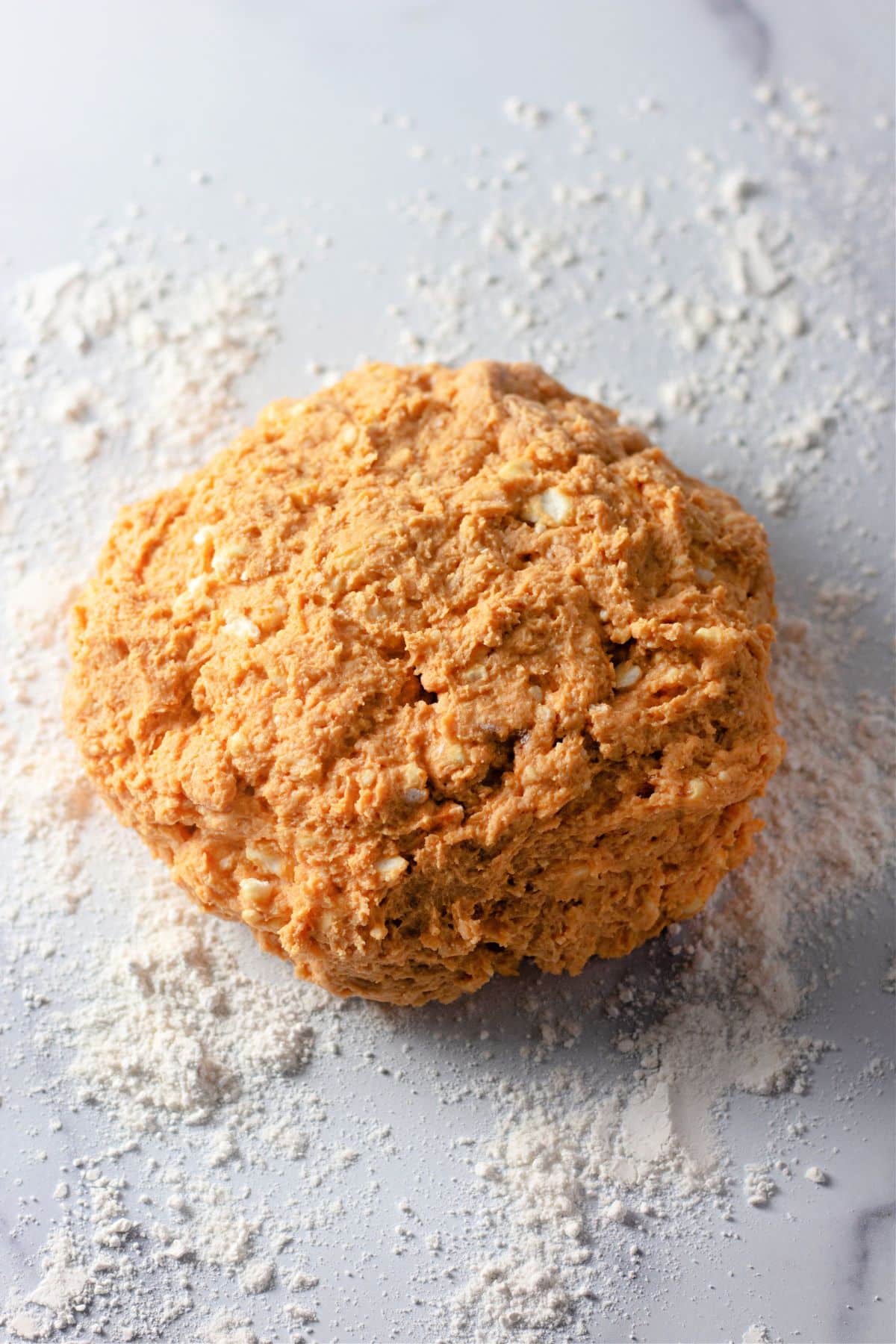 Dough ball on a counter ready to be rolled out.