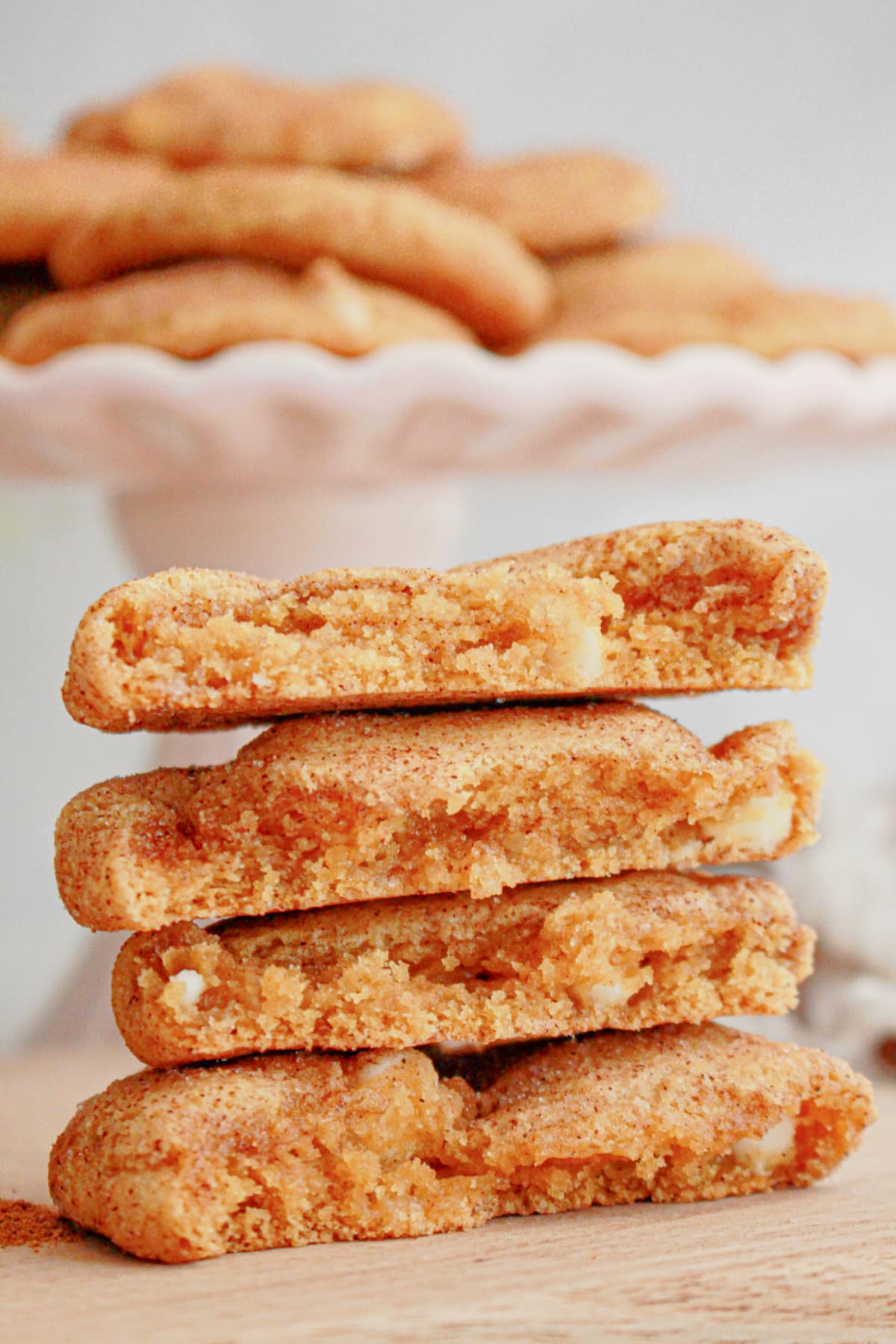 two pumpkin snickerdoodles broken on half and stacked on top of each other.
