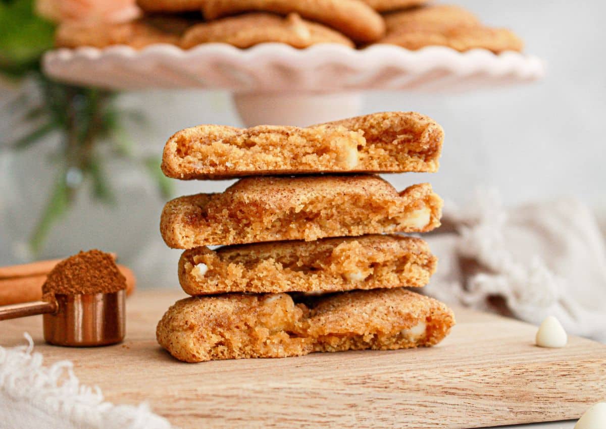 two pumpkin snickerdoodles broken on half and stacked on top of each other.