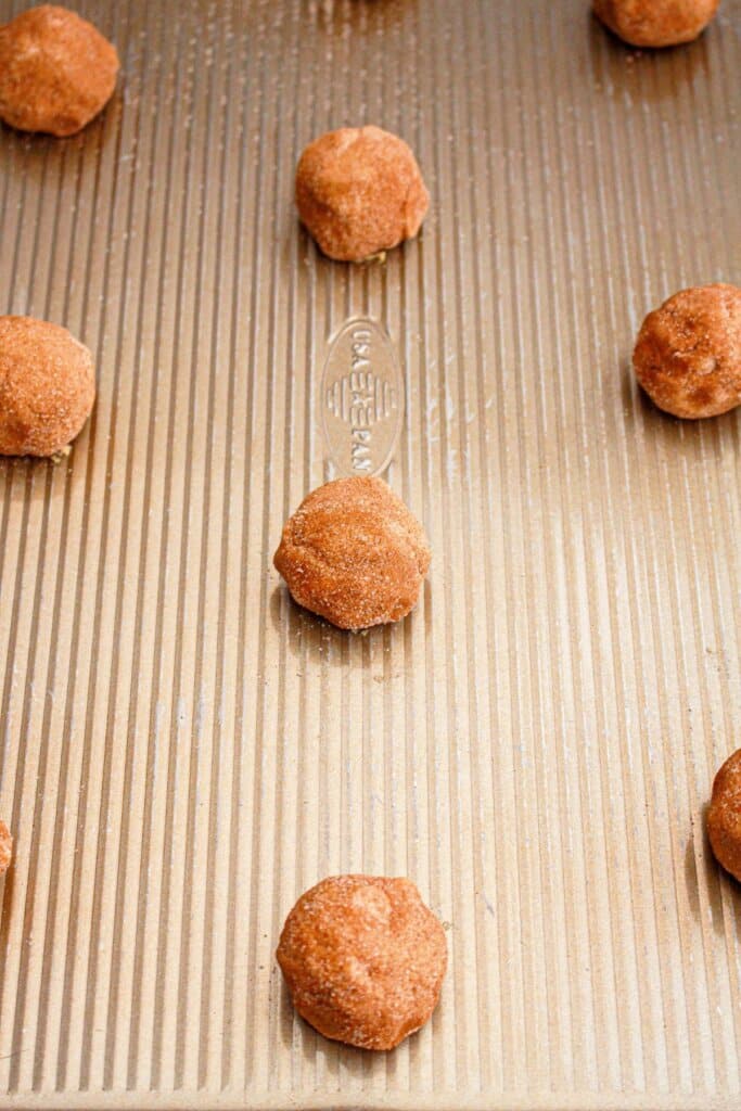 cookie dough balls on a baking tray.